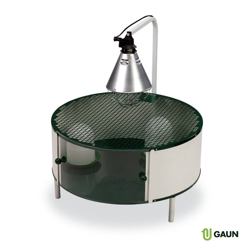 Circular chick brooding cage with a heat lamp and waterer.