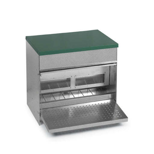 Galvanized treadle feeder with a green lid and a perforated tray.