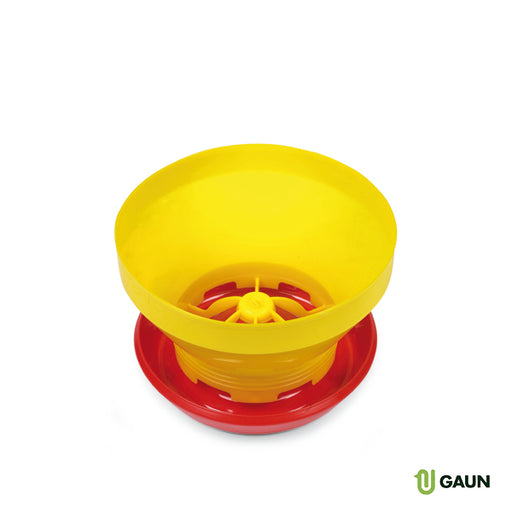 Yellow and red plastic feeder with a wide opening and a central dispensing mechanism.