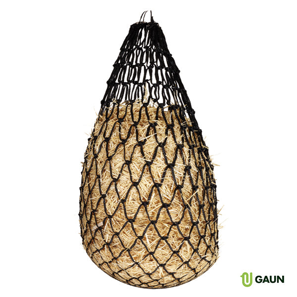 A black mesh hay net filled with hay.