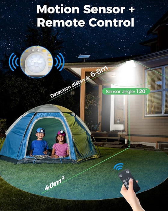 Solar light with motion sensor and remote control, illuminating a tent and yard.
