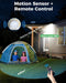 Solar light with motion sensor and remote control, illuminating a tent and yard.